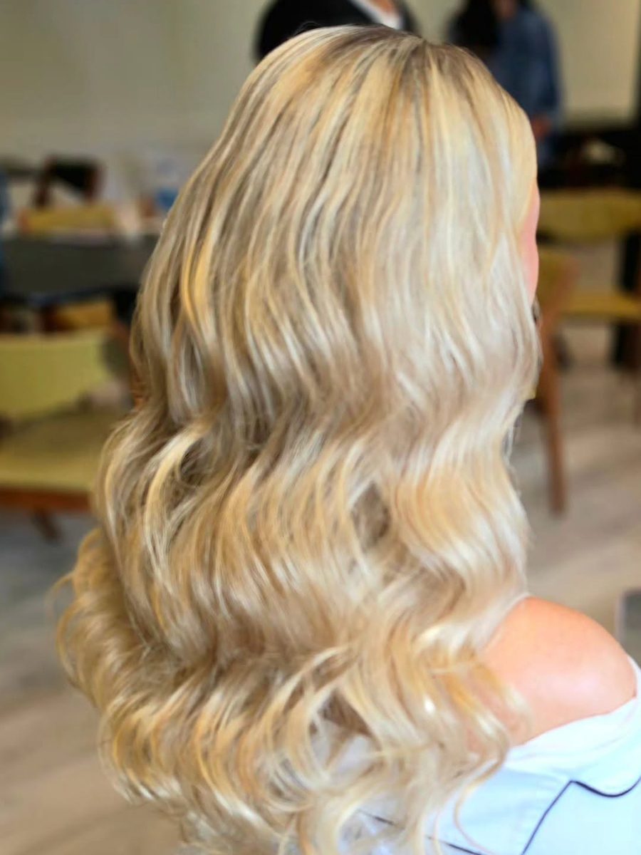 Bride with long, soft blonde waves, seen from behind