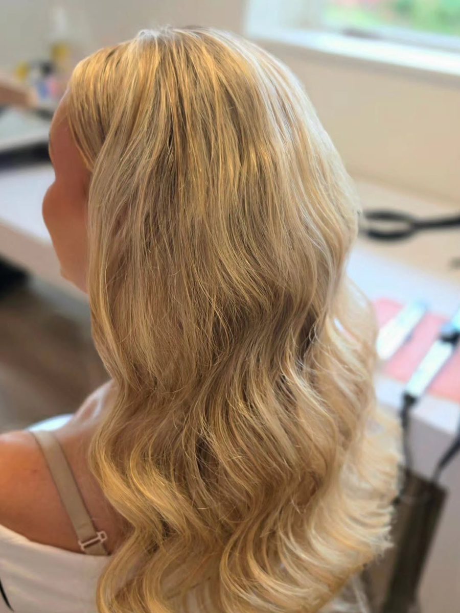 Long blonde half-up style with soft curls