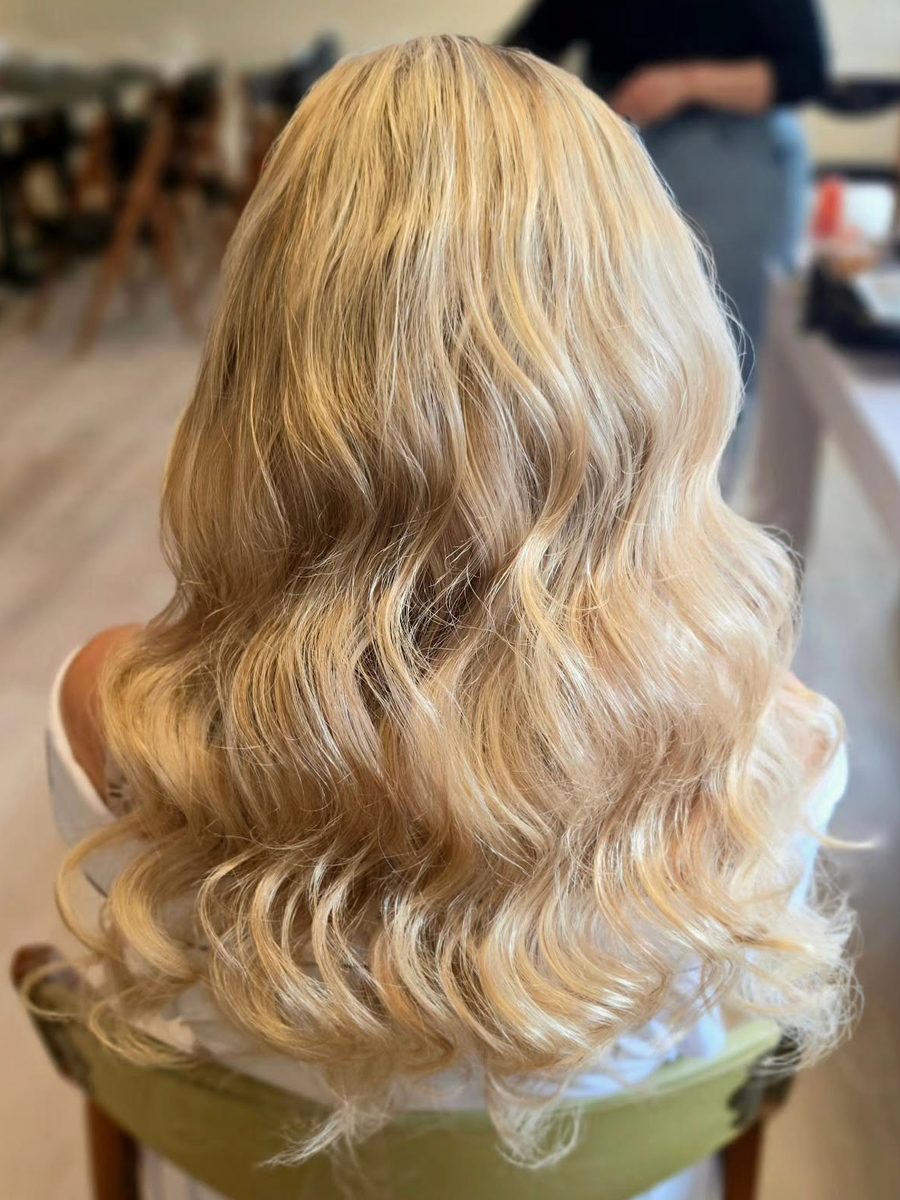 Full head of glossy blonde waves, seen from behind